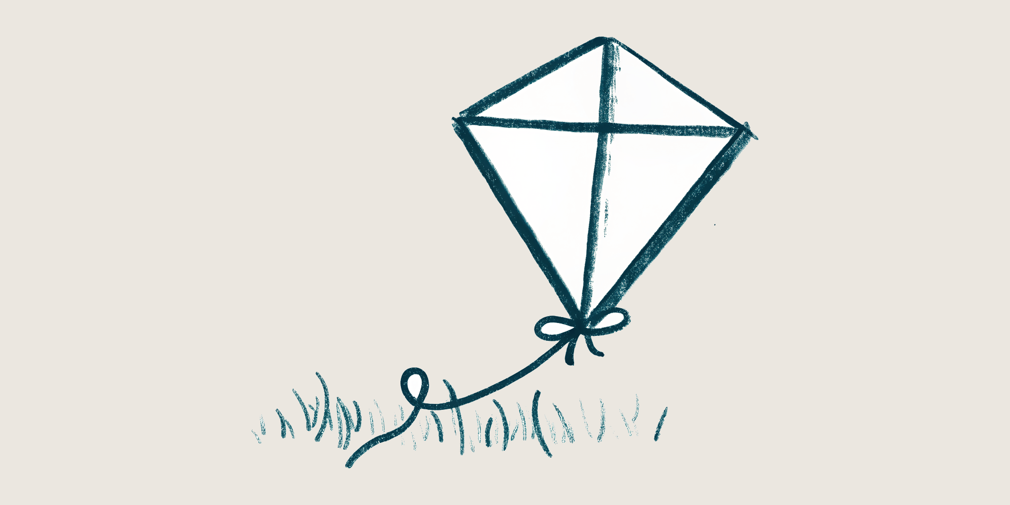 A hand-drawn kite lying on the grass, its string loosely coiled, waiting for wind